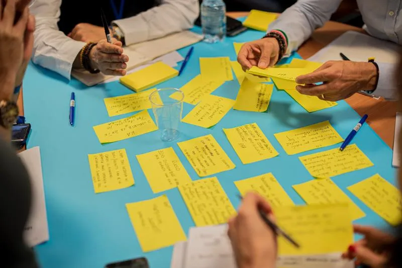 People sitting around table collaboration on research 